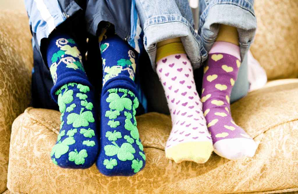 two pairs of feet wearing crazy socks